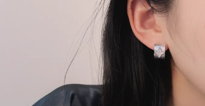 Silver earrings shown in a wearing context