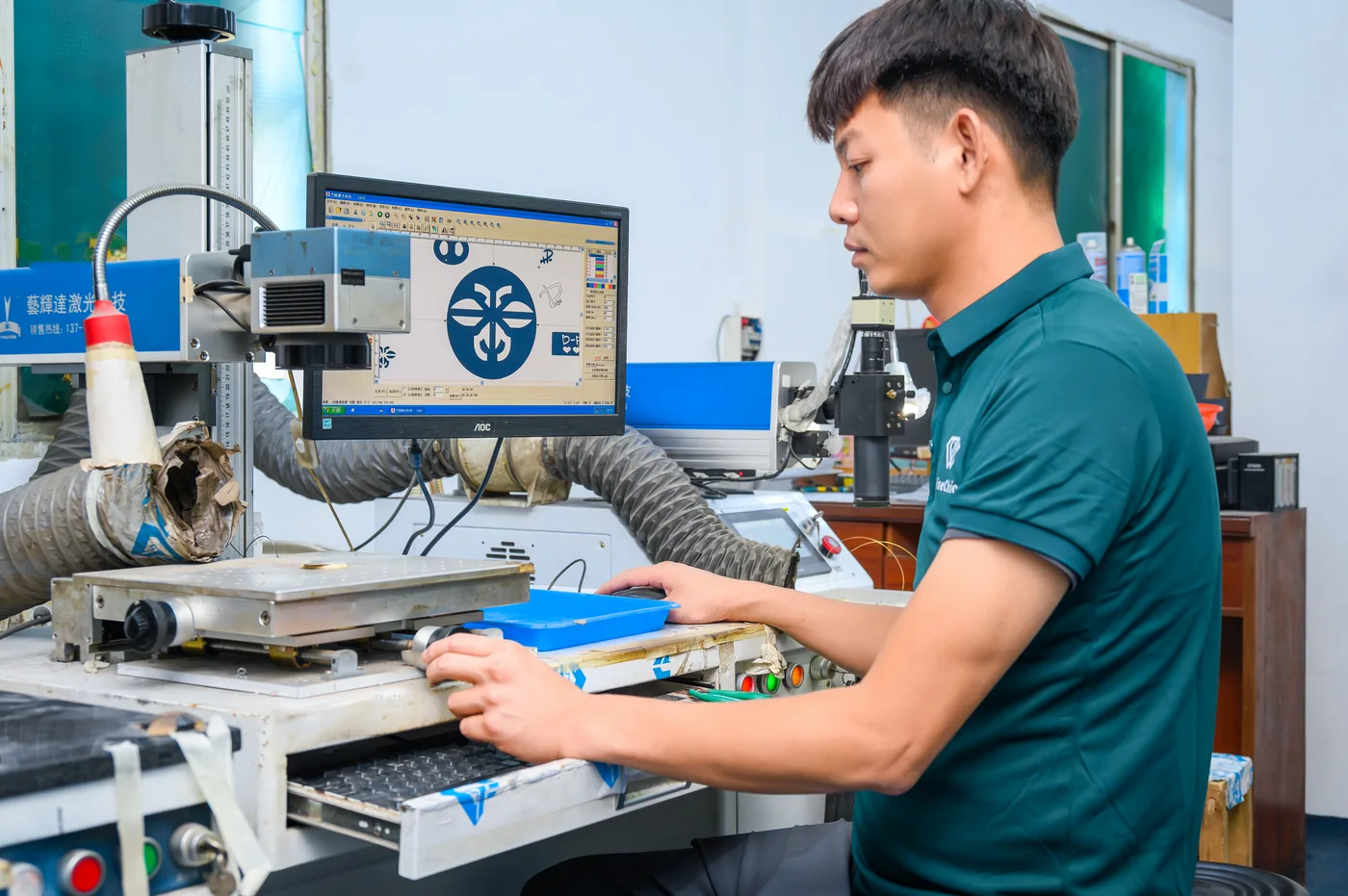Fine Chic technician operating laser marking equipment